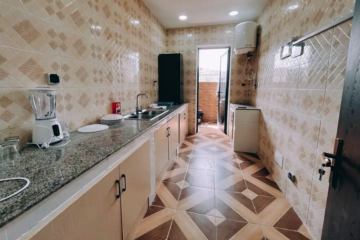 Cocina alicatada con un termo eléctrico colgado en la pared, uno de los aparatos que pide una línea propia